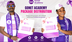 Two students smile as they received their packages on Monday
